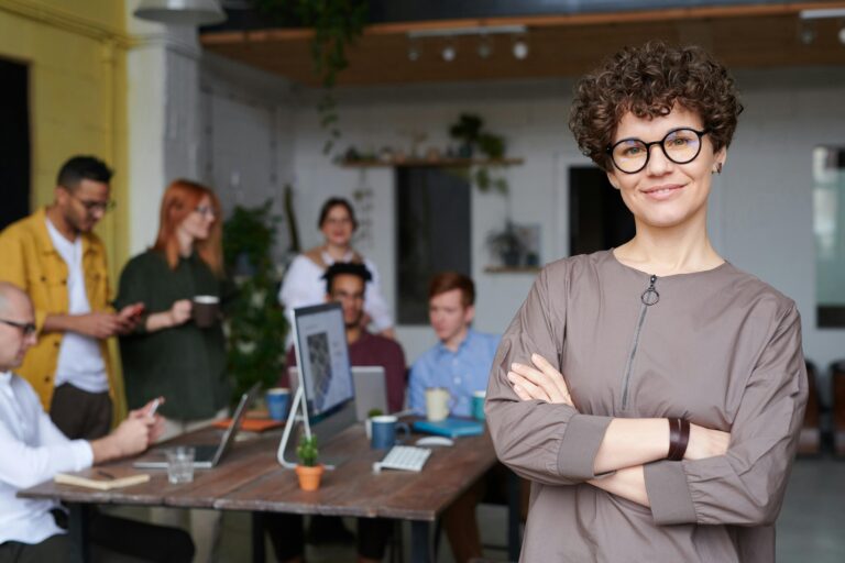 Mujer joven al frente de un equipo, representando el nuevo liderazgo millenial